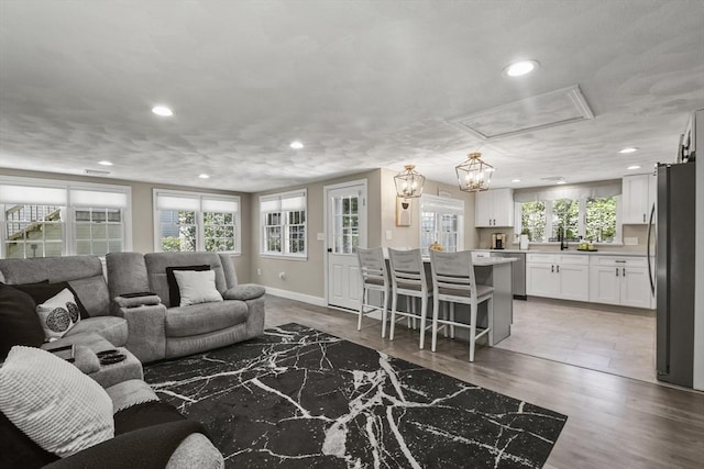 369 Vernon St, Wakefield, MA 01880 - living area with recessed lighting, light wood-style floors, and attic access