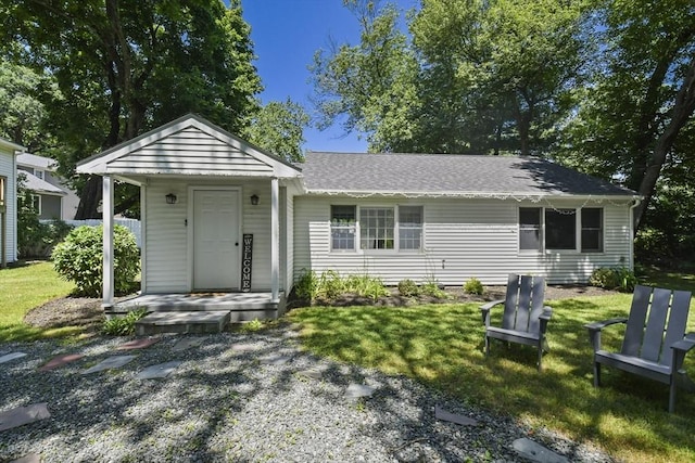 369 Vernon St, Wakefield, MA 01880 - view of front of home with a front yard and a shingled roof