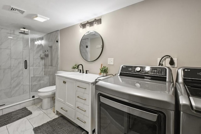 369 Vernon St, Wakefield, MA 01880 - full bathroom with marble look tile flooring, independent washer and dryer, vanity, and a stall shower
