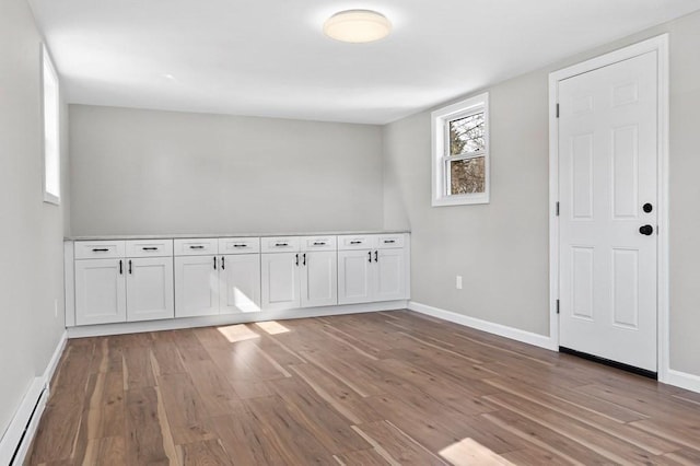 369 Vernon St, Wakefield, MA 01880 - empty room with baseboard heating and light wood finished floors