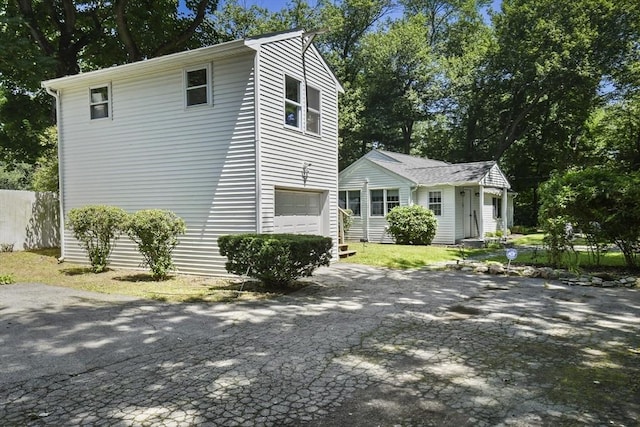 369 Vernon St, Wakefield, MA 01880 - view of side of property featuring a garage, driveway, and an outdoor structure