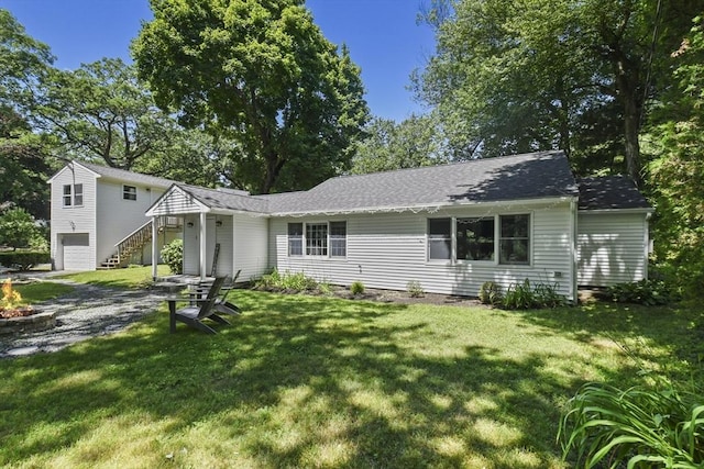 369 Vernon St, Wakefield, MA 01880 - view of front of home featuring an attached garage, a front yard, stairway, and roof with shingles