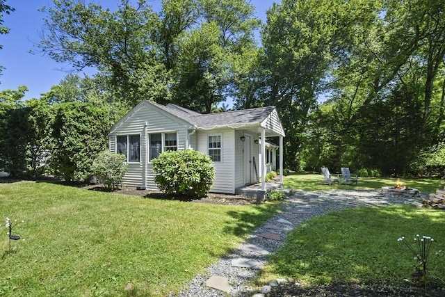 369 Vernon St, Wakefield, MA 01880 - view of front of home featuring an outdoor fire pit and a front lawn