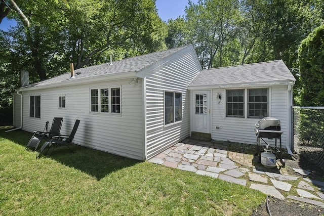 369 Vernon St, Wakefield, MA 01880 - back of property with roof with shingles and a lawn