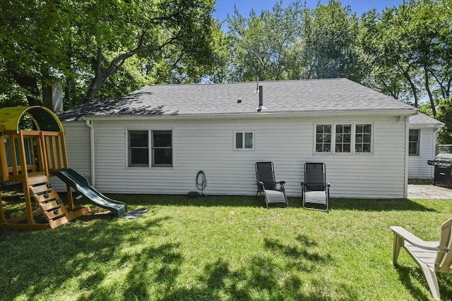 369 Vernon St, Wakefield, MA 01880 - rear view of house featuring a playground, a yard, and roof with shingles