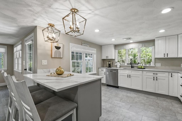 369 Vernon St, Wakefield, MA 01880 - kitchen with dishwasher, white cabinets, light stone countertops, recessed lighting, and a breakfast bar