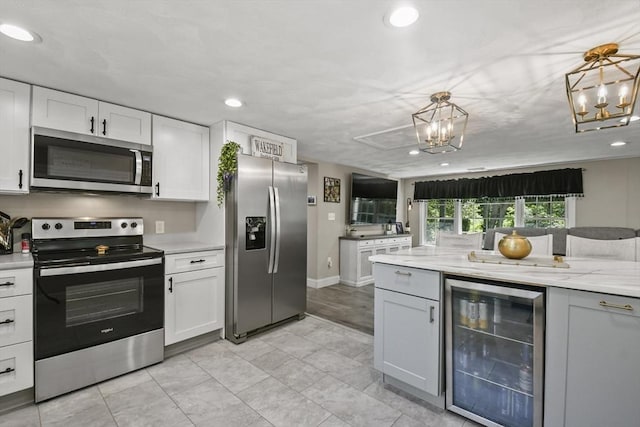369 Vernon St, Wakefield, MA 01880 - kitchen featuring wine cooler, stainless steel appliances, a chandelier, white cabinets, and recessed lighting