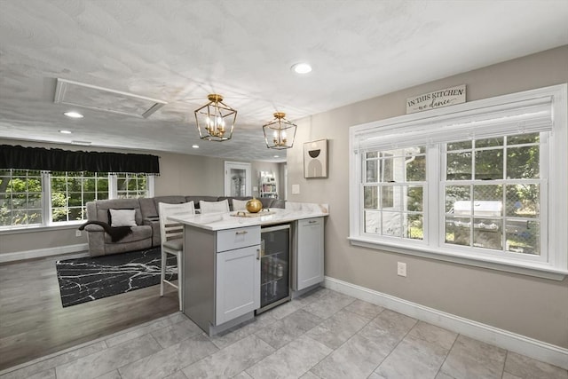 369 Vernon St, Wakefield, MA 01880 - kitchen with beverage cooler, recessed lighting, gray cabinets, open floor plan, and a peninsula