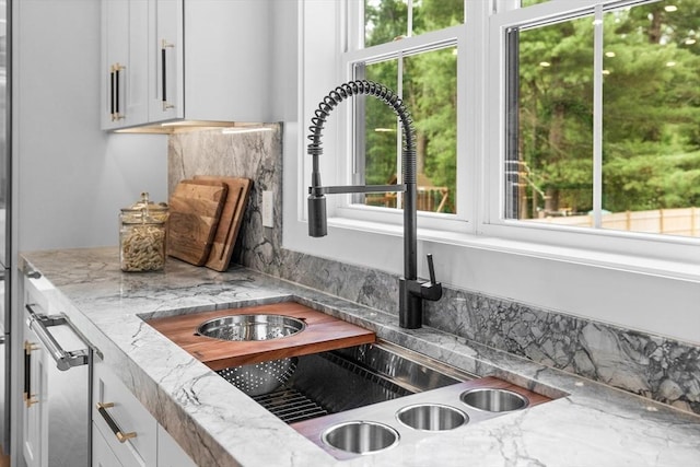 1 Maud Graham Cir, Burlington, MA 01803 - kitchen with healthy amount of natural light, light stone countertops, and white cabinetry