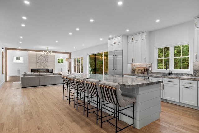 1 Maud Graham Cir, Burlington, MA 01803 - kitchen featuring stainless steel built in refrigerator, a large island, white cabinets, recessed lighting, and dark stone counters