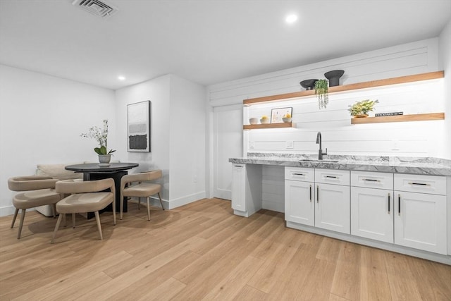 1 Maud Graham Cir, Burlington, MA 01803 - kitchen with open shelves, light wood-style flooring, light stone countertops, white cabinetry, and recessed lighting