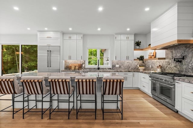 1 Maud Graham Cir, Burlington, MA 01803 - kitchen with high quality appliances, plenty of natural light, custom range hood, light stone countertops, and recessed lighting