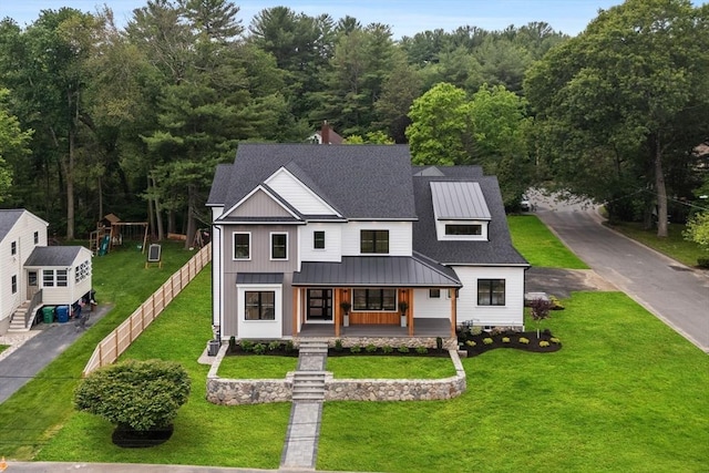 1 Maud Graham Cir, Burlington, MA 01803 - modern farmhouse style home featuring a porch, a metal roof, a standing seam roof, a playground, and a front lawn