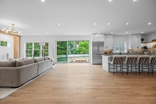 1 Maud Graham Cir, Burlington, MA 01803 - living area featuring light wood-type flooring, a chandelier, and recessed lighting