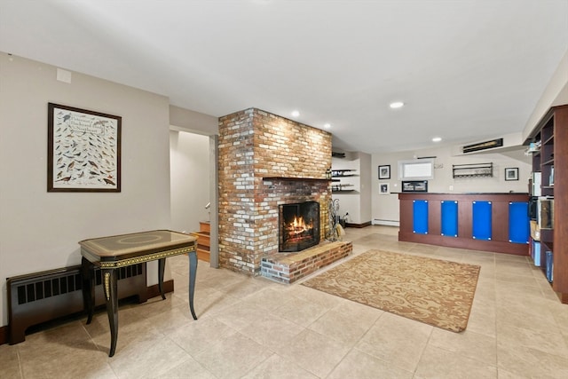 living room with a baseboard heating unit, a brick fireplace, and light tile patterned flooring