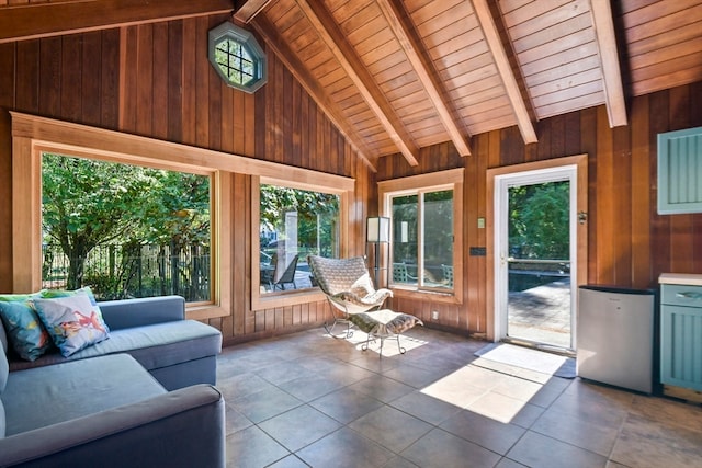 unfurnished sunroom featuring vaulted ceiling with beams and wooden ceiling