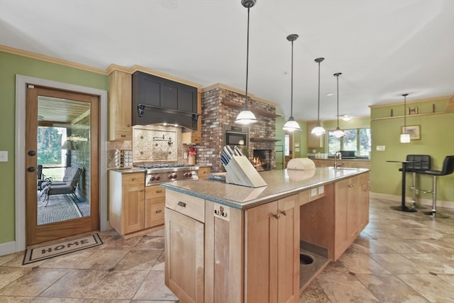 kitchen with decorative backsplash, a kitchen island with sink, stainless steel appliances, decorative light fixtures, and light brown cabinetry