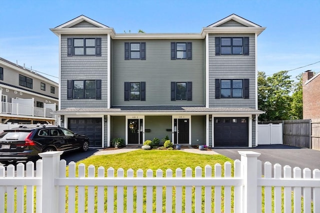 125 Ash St Unit 1, Waltham, MA 02453 - view of front of property featuring a fenced front yard, a garage, and driveway