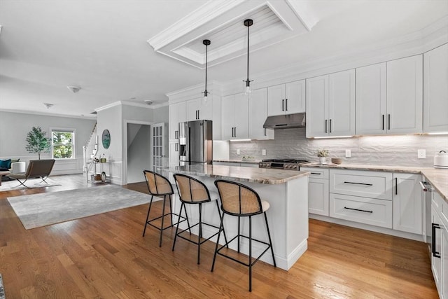 125 Ash St Unit 1, Waltham, MA 02453 - kitchen with stainless steel appliances, under cabinet range hood, open floor plan, decorative backsplash, and crown molding