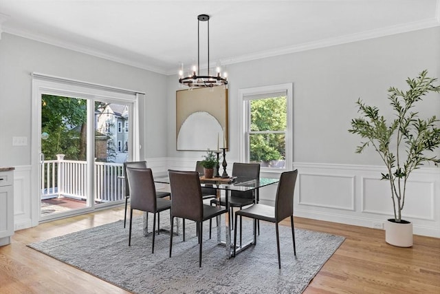 125 Ash St Unit 1, Waltham, MA 02453 - dining space featuring a chandelier, healthy amount of natural light, light wood-style floors, ornamental molding, and wainscoting