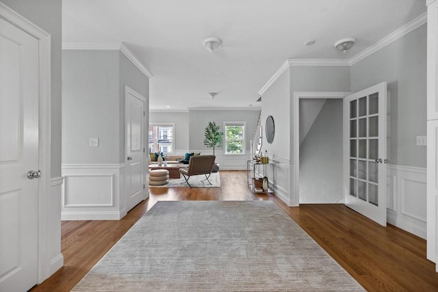 125 Ash St Unit 1, Waltham, MA 02453 - foyer with dark wood finished floors, crown molding, a decorative wall, and a wainscoted wall