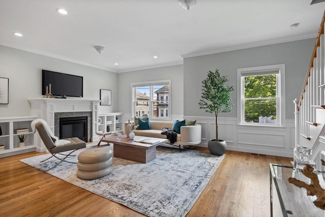 125 Ash St Unit 1, Waltham, MA 02453 - living area featuring stairway, plenty of natural light, a high end fireplace, wood finished floors, and crown molding