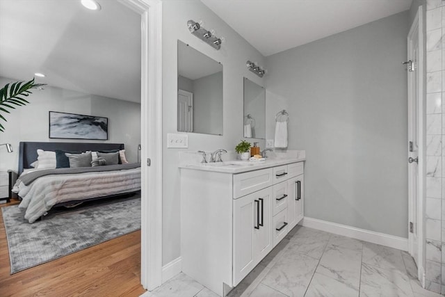 125 Ash St Unit 1, Waltham, MA 02453 - ensuite bathroom with double vanity, marble finish floors, and recessed lighting