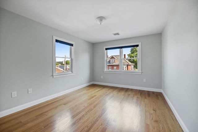 125 Ash St Unit 1, Waltham, MA 02453 - empty room with healthy amount of natural light and light wood finished floors