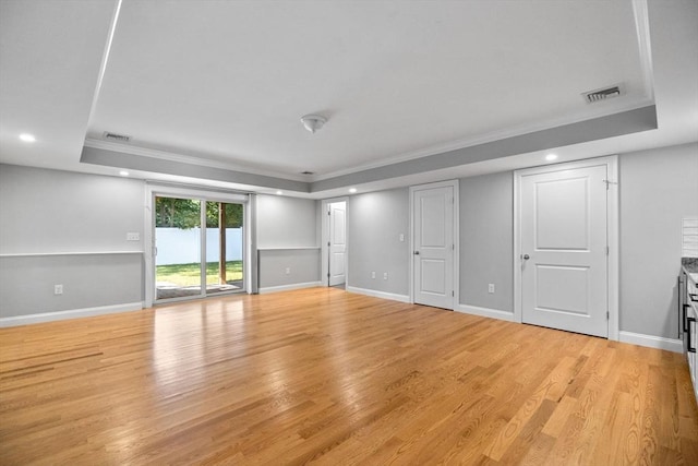 125 Ash St Unit 1, Waltham, MA 02453 - unfurnished living room with a raised ceiling, ornamental molding, recessed lighting, and light wood-style flooring
