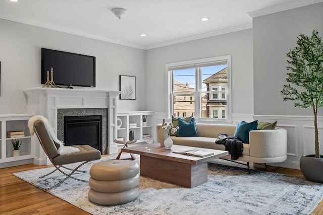 125 Ash St Unit 1, Waltham, MA 02453 - living area featuring wood finished floors, ornamental molding, recessed lighting, a glass covered fireplace, and wainscoting