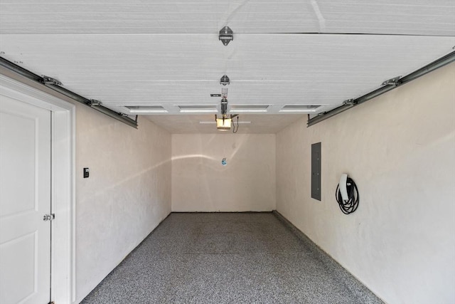 125 Ash St Unit 1, Waltham, MA 02453 - garage featuring a garage door opener and electric panel