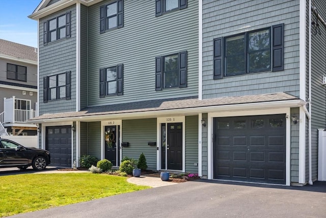 125 Ash St Unit 1, Waltham, MA 02453 - multi unit property with a garage, a front lawn, and driveway