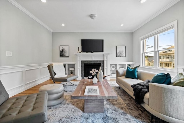 125 Ash St Unit 1, Waltham, MA 02453 - living room with wood finished floors, recessed lighting, ornamental molding, a fireplace, and a wainscoted wall