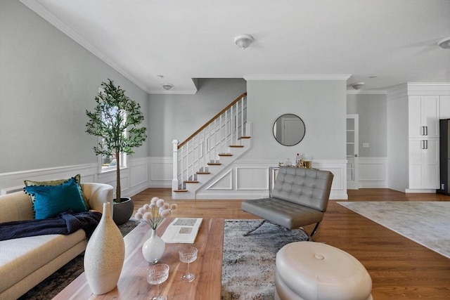 125 Ash St Unit 1, Waltham, MA 02453 - living area featuring wood finished floors, stairway, crown molding, and a wainscoted wall