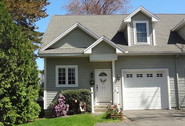 49 Camden St Unit 49, South Hadley, MA 01075 - view of front of home featuring a shingled roof, a garage, and driveway