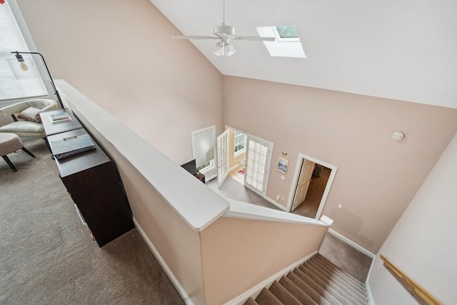 49 Camden St Unit 49, South Hadley, MA 01075 - stairway featuring carpet flooring, high vaulted ceiling, a skylight, a ceiling fan, and baseboards