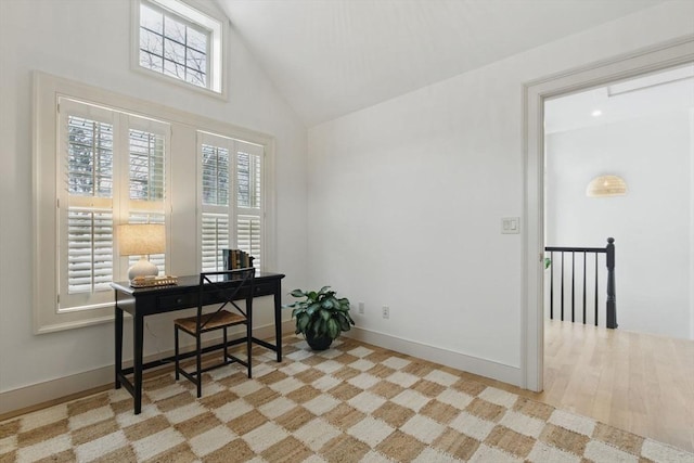 office space featuring high vaulted ceiling and baseboards