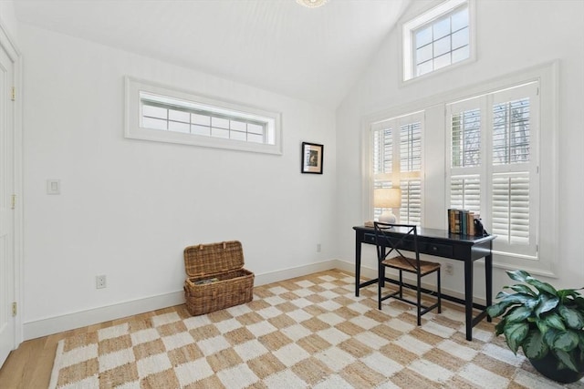 office space featuring vaulted ceiling and baseboards