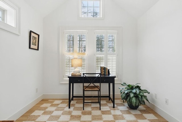 office featuring lofted ceiling and baseboards