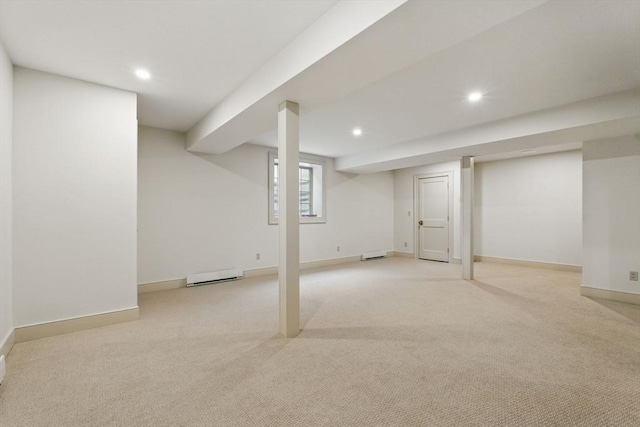 below grade area featuring baseboards, baseboard heating, light colored carpet, and recessed lighting