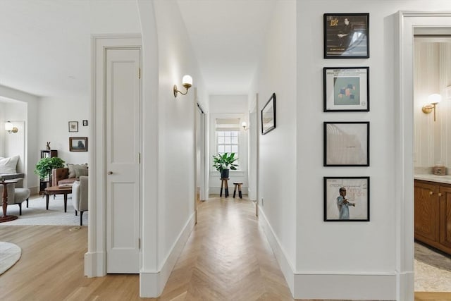 hall featuring parquet floors and baseboards