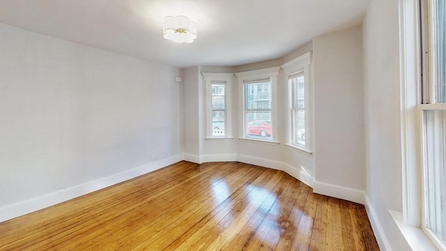 unfurnished room with light wood-type flooring