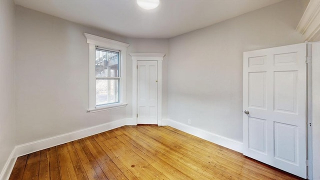 unfurnished room with hardwood / wood-style floors