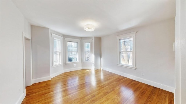 empty room with light hardwood / wood-style flooring