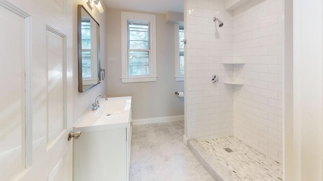 bathroom with vanity and tiled shower