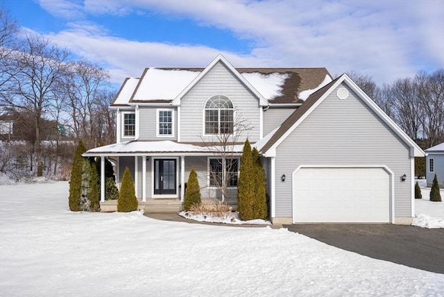 view of front of house with a garage, driveway, and a porch