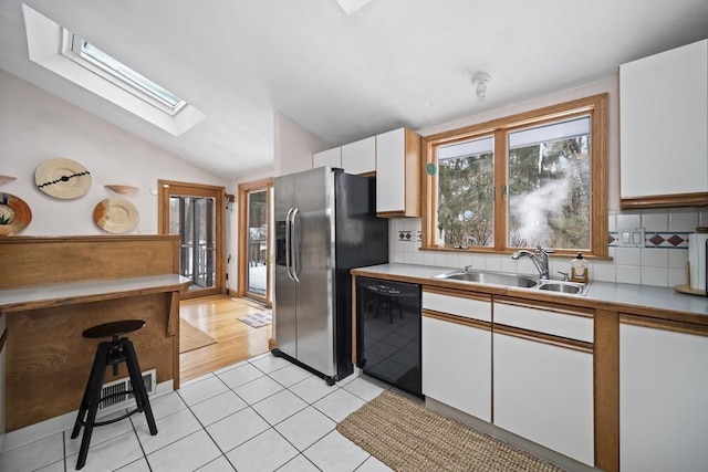 kitchen featuring a sink, white cabinetry, black dishwasher, light countertops, and stainless steel fridge with ice dispenser