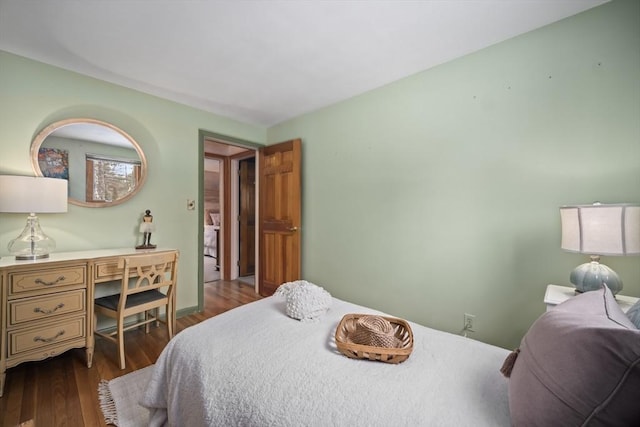 bedroom with dark wood finished floors