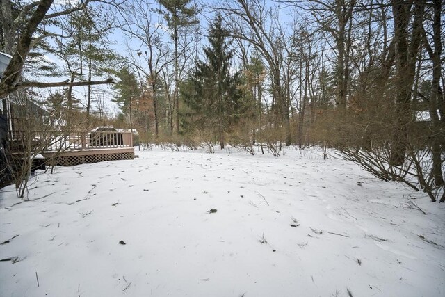 snowy yard with a wooden deck