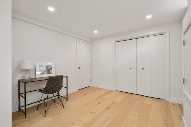 office featuring baseboards, light wood-type flooring, and recessed lighting